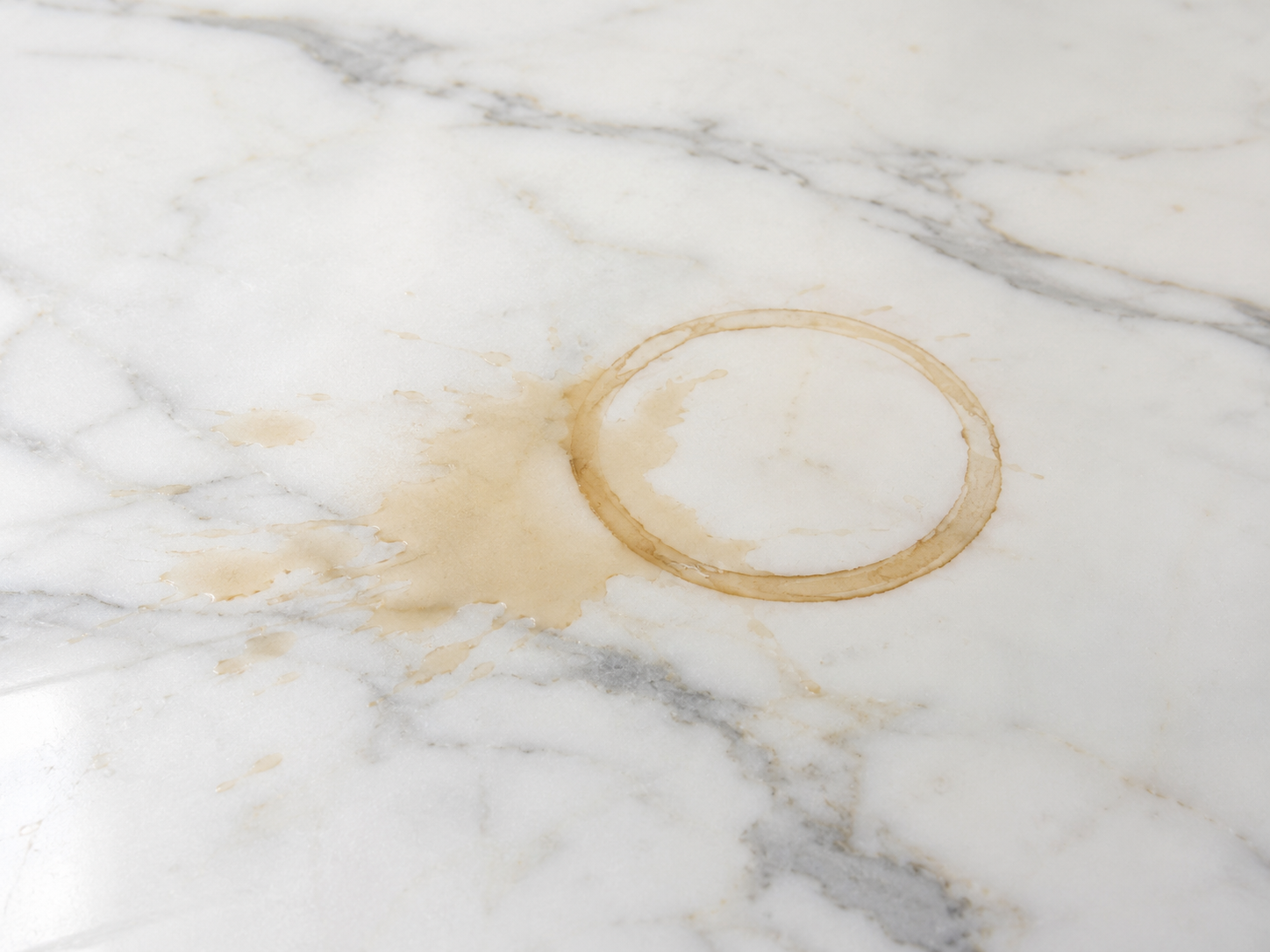 Coffee ring and coffee spill on white marble