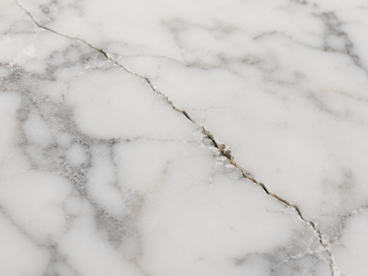 Close-up of a visible crack running through white marble